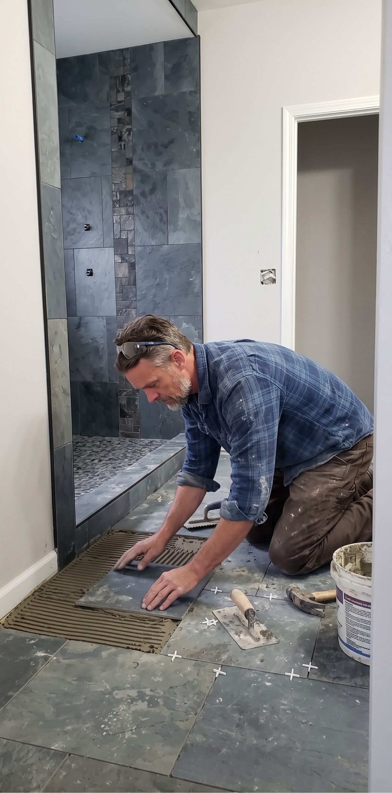 Laying the bathroom floor to meet the finished shower