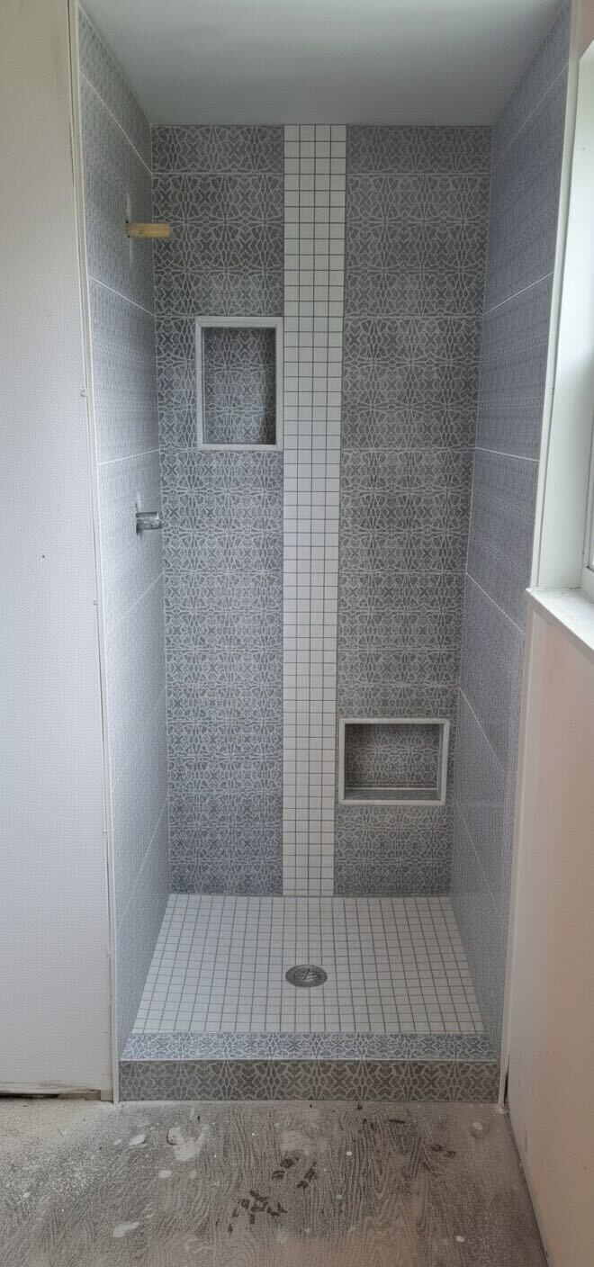 Gray patterned tile shower with bench